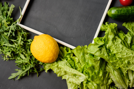 frame for copy space with lettuce,lemon, pepper, cucumbers and cherry tomatoes on a white background. Copy spaceの写真素材
