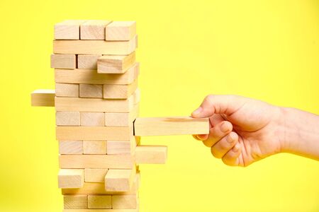 Game of wooden blocks on a yellow background,の写真素材