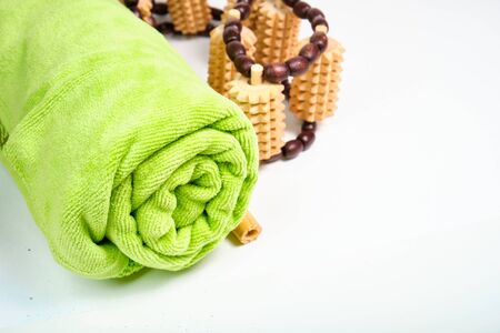 Green towel and wooden massagerの写真素材