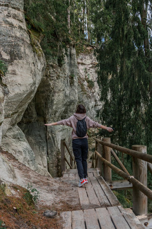 girl tourist and Wooden trail and stairs in the deep green forest in summerの写真素材