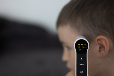 Infrared Thermometer Measuring Childs Temperature Medical Check Conceptの写真素材