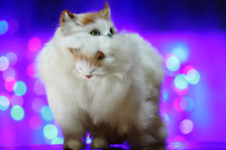 Toy cat with a kitten in his mouthの写真素材