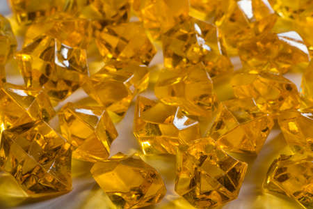 Granules of the transparent yellow plastic in the form of jewelsの写真素材