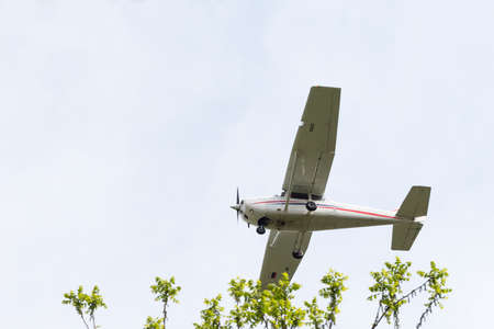 Flying a light single-engine plane in skyのeditorial素材