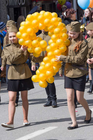 Two girls at the parade with balloons in form of digit nine (the date May 9 is Victory Day in World War II). Pyatigorsk, Russiaのeditorial素材