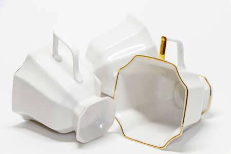 Three porcelain coffee cups lying on one side の写真素材