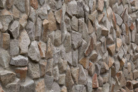 The texture of the wall, lined with natural stone, at an angle to the observerの写真素材