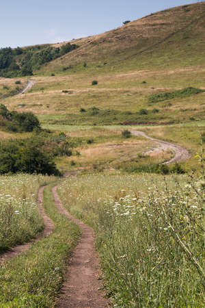 A dirt road in the highlands on a summer dayの写真素材