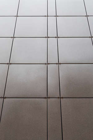 The external wall of the building revetted with a brown tile, backgroundの写真素材