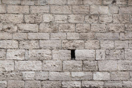 Old wall of tuff in light of morning sun, backgroundの写真素材