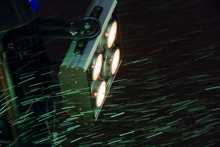Traces of snowflakes flying in the spotlight