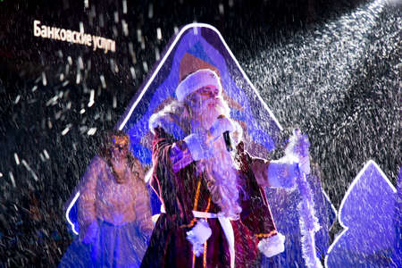 PYATIGORSK, RUSSIA - DECEMBER 31, 2014: Grandfather Frost on stage in the rays of light fixtures. New Yearのeditorial素材