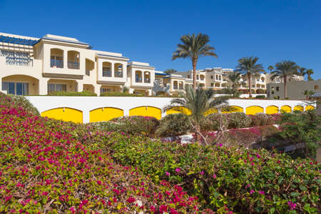 SHARM EL-SHEIKH, EGYPT - NOVEMBER 30, 2014: Holiday Houses at the hotel Grand Oasis Resort against many flowering plantsのeditorial素材