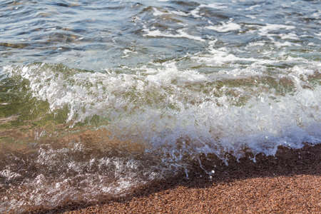 Water of the sea wave shining in sun beams