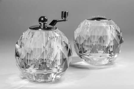 Spherical salt shaker and manual mill on white backgroundの写真素材