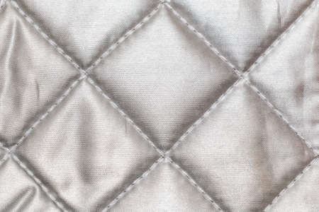 The texture of shiny fabric stitched squares, backgroundの写真素材