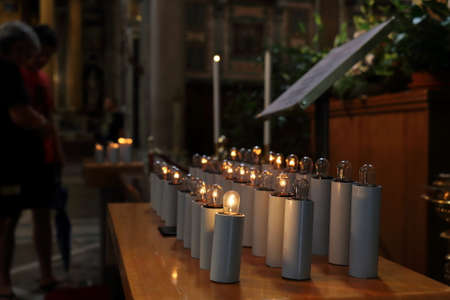 Electric candles with a warm glow in the church (basilica)