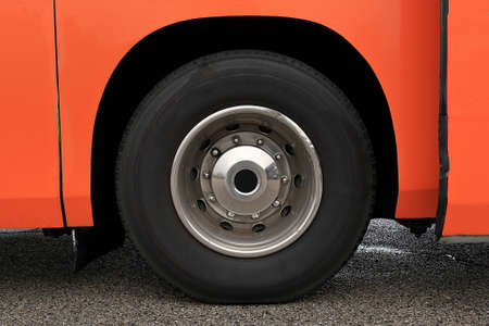 Wheel with damaged rim on a wet asphalted roadの写真素材
