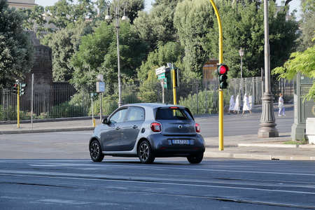 Rome, Italy - August 17, 2015: Morning. The car which stopped on red light on street of Rome. Nuns...