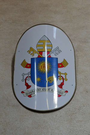 Coat of arms of Pope Francis Jorge Mario Bergoglio on a wall in Basilica in Rome, Italyのeditorial素材
