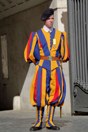 Vatican - August 18, 2015: Member of the Pontifical Swiss Guard stand guard near entrance in Saint Peters Basilicaのeditorial素材