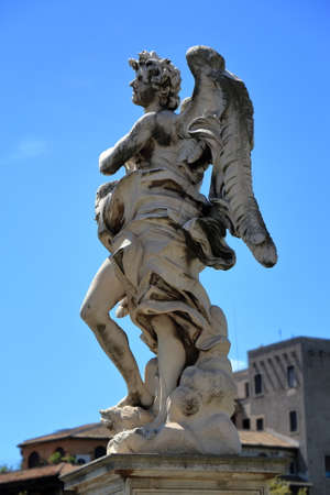 Angel with the Superscription "Regnavit a ligno deus" in brige Ponte Sant'Angelo in Rome, Italy. Side view. Sculptor Gian Lorenzo Bernini and son Paolo.の写真素材