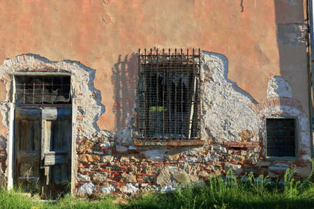 Old building in morning sun with damaged from the time walls. Background.の写真素材