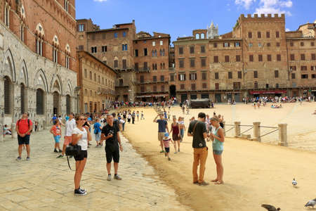 Siena, Italy - August 20, 2015: Tourists and buildings in Piazza del Campo in Siena, Italyのeditorial素材