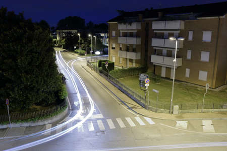 Italy - August 20, 2015: Night view of the streets and light trace of cars in Italy