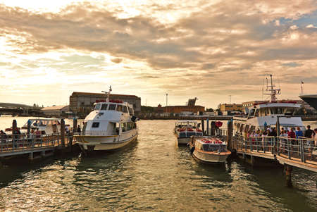 Venice, Italy - August 21, 2015: Landing of tourists on a boat for a tour on the canals of Venice....