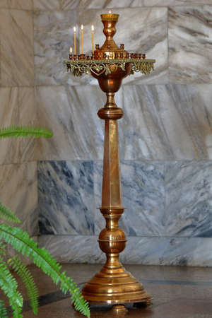 Burning candles in golden candlestick inside of Narzan Gallery in Kislovodsk, Russia.