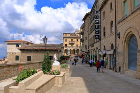 San Marino, Italy - August 22, 2015: View of Via Donna Felicissima in sunny day. Unrecognized people go along the road from yellow stoneのeditorial素材