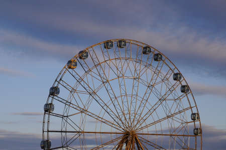 Fragment of a Ferris wheel against the background of the evening skyの写真素材