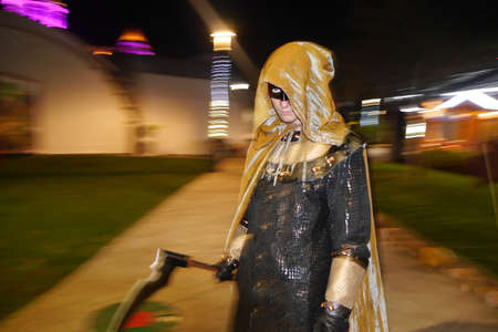 Adler, Russia - November 3, 2016: A man in a death suit with a scythe. Blurred in motion with focus on face. Halloween in Sochi Park in Adlerのeditorial素材