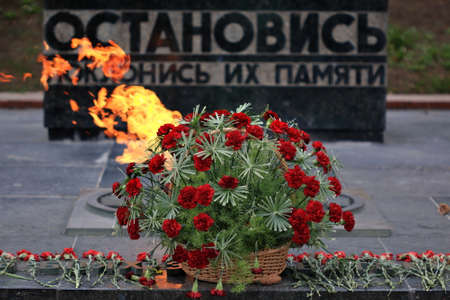 Pyatigorsk, Russia - April 1, 2017: Basket with flowers against the flame. Memorial "Eternal Flame" to the fallen soldiers during the Great Patriotic War in Pyatigorsk. Stavropol Regionのeditorial素材