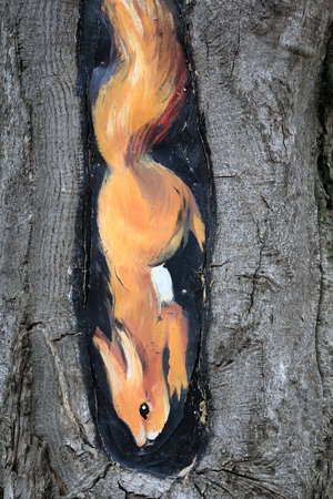 Pyatigorsk, Russia - April 1, 2017: Painted on the trunk of a tree red squirrel in the resort area of Pyatigorsk.のeditorial素材