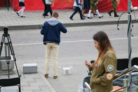Pyatigorsk, Russia - May 9, 2017: Celebration of the Victory Day in the WWII. The cameraman prepares the equipment for shooting from quadrocopterのeditorial素材