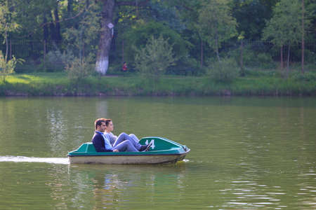Pyatigorsk, Russia - May 13, 2017: People are sailing in the catamaran on the lake. Amusement Park in Pyatigorsk, Russiaのeditorial素材