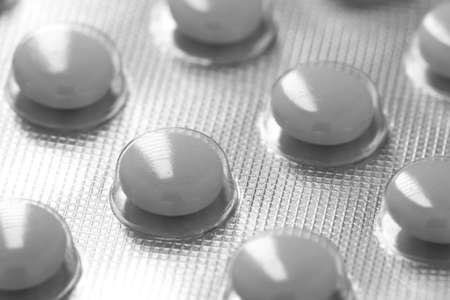 White medicine pills in blister pack. The concept of medicine or drug abuseの写真素材