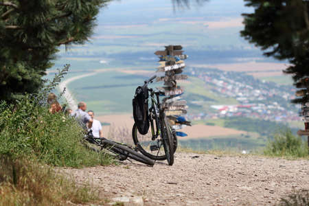 Two black bicycles next to the direction signs at the top of the Mashuk mountain. Summer....