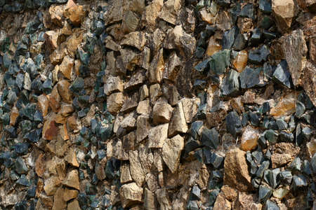 Stones and large pieces of yellow and green glass. Abstract background