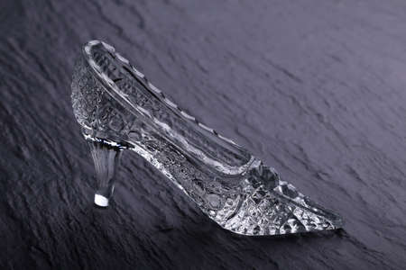 Crystal Cinderella shoes on a stone background. Glass decoration for homeの写真素材
