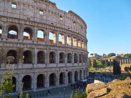 View of the Colosseum, also known as the Flavian Amphitheatre with tourists near it. Rome, Italy.