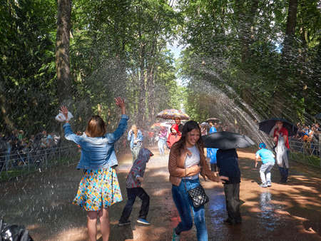 Peterhof, St. Petersburg, Russia - August 3, 2017: The laughing tourists in the fountain-crackerのeditorial素材