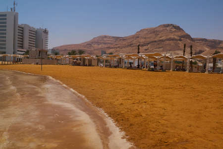 Ein Bokek, Israel - June 10, 2017: Tourists is resting on the beach in Ein Bokek. Is a resort district on the Israeli shore of the Dead Seaのeditorial素材