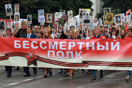 Pyatigorsk, Russia - May 9, 2018: People in column carrying portraits of their ancestors of those killed in hostilities and portraits participants in World War II. Text on the banner Immortal Regimentのeditorial素材