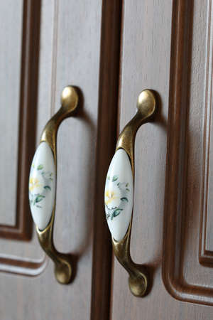 Two handles of brown cabinet door close-upの写真素材