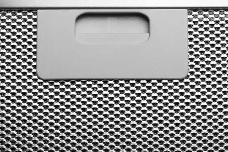 Metal grid with handle for opening the hatch close-up. Details of air filter. Monochrome image....