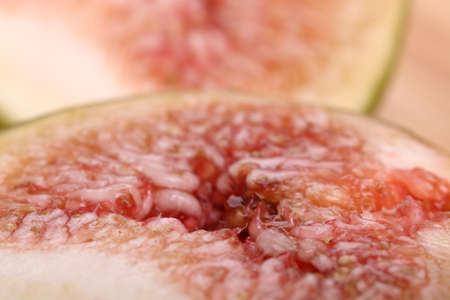 A sliced figs with seeds close-up. Abstract background