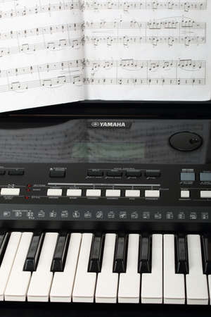Georgievsk, Russia - July 22, 2018: Yamaha synthesizer with musical notes close-up. Music learning...